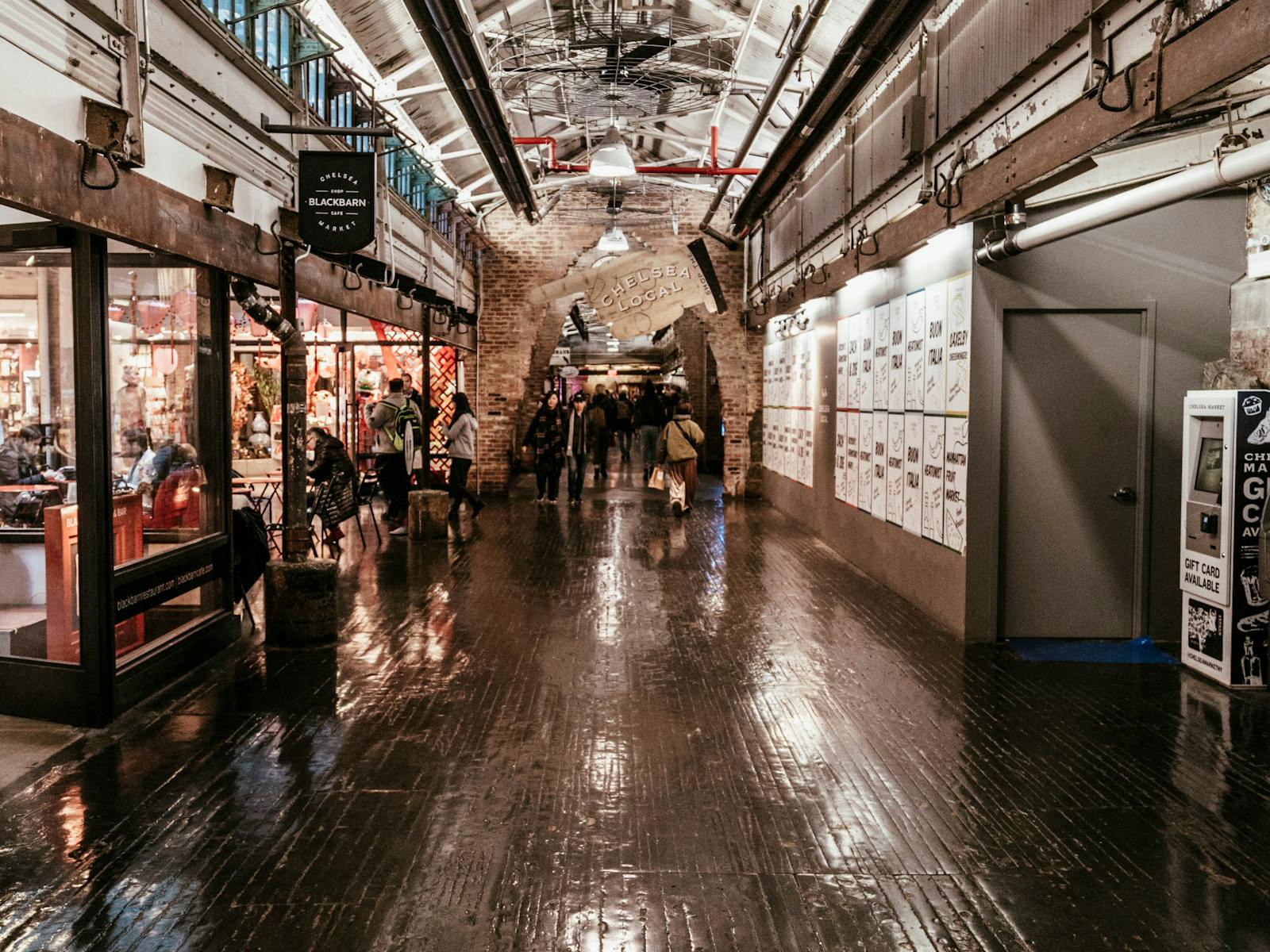 Chelsea Market interior with brick walls, storefronts, and visitors