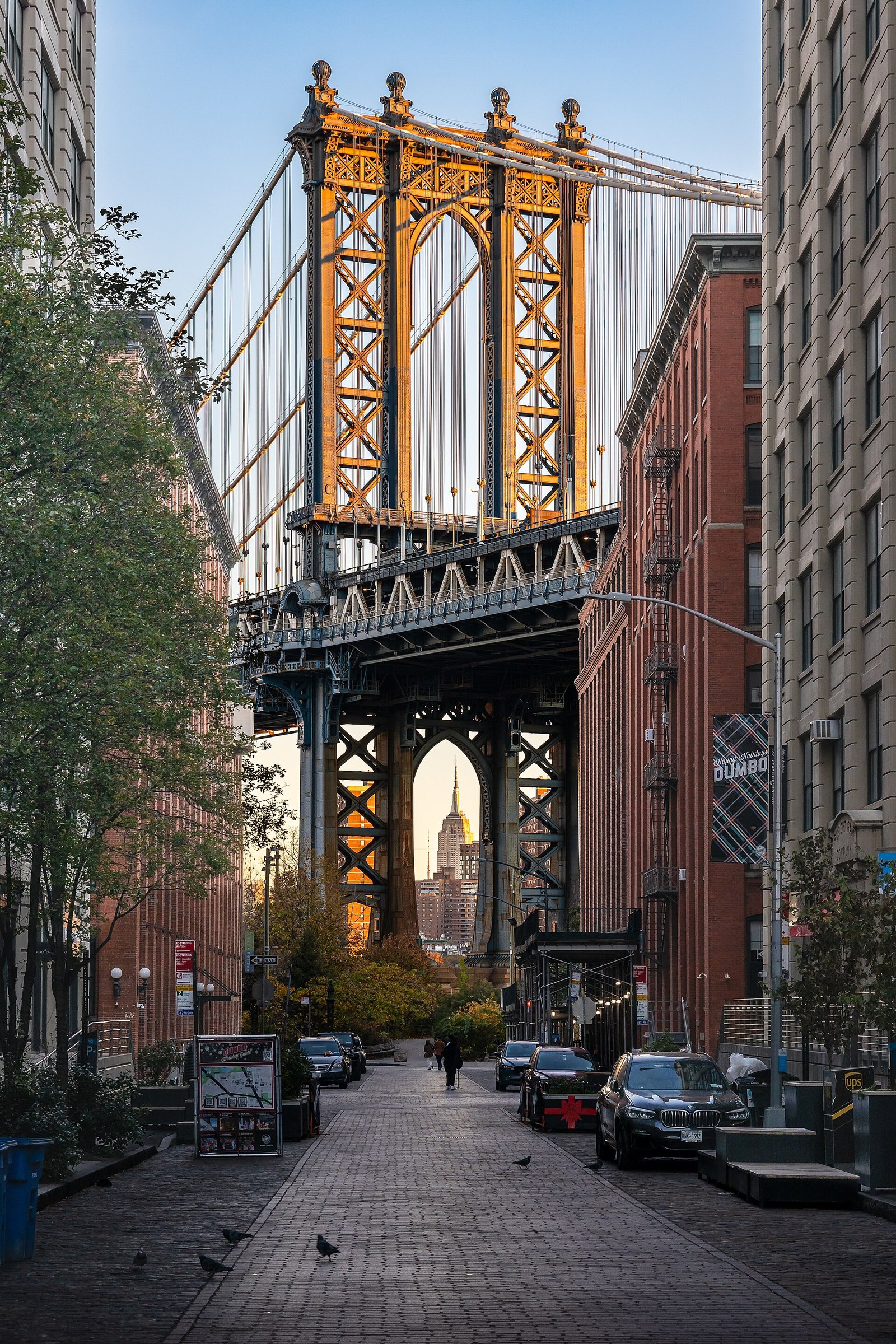 The Manhattan Bridge framed by buildings on Washington Street in DUMBO