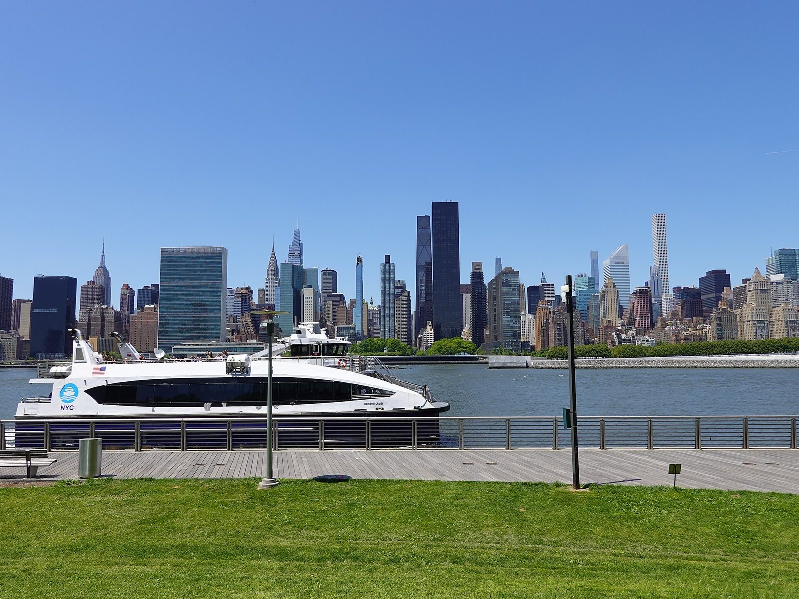 An NYC Ferry and Manhattan skyline seen from Gantry Plaza State Park